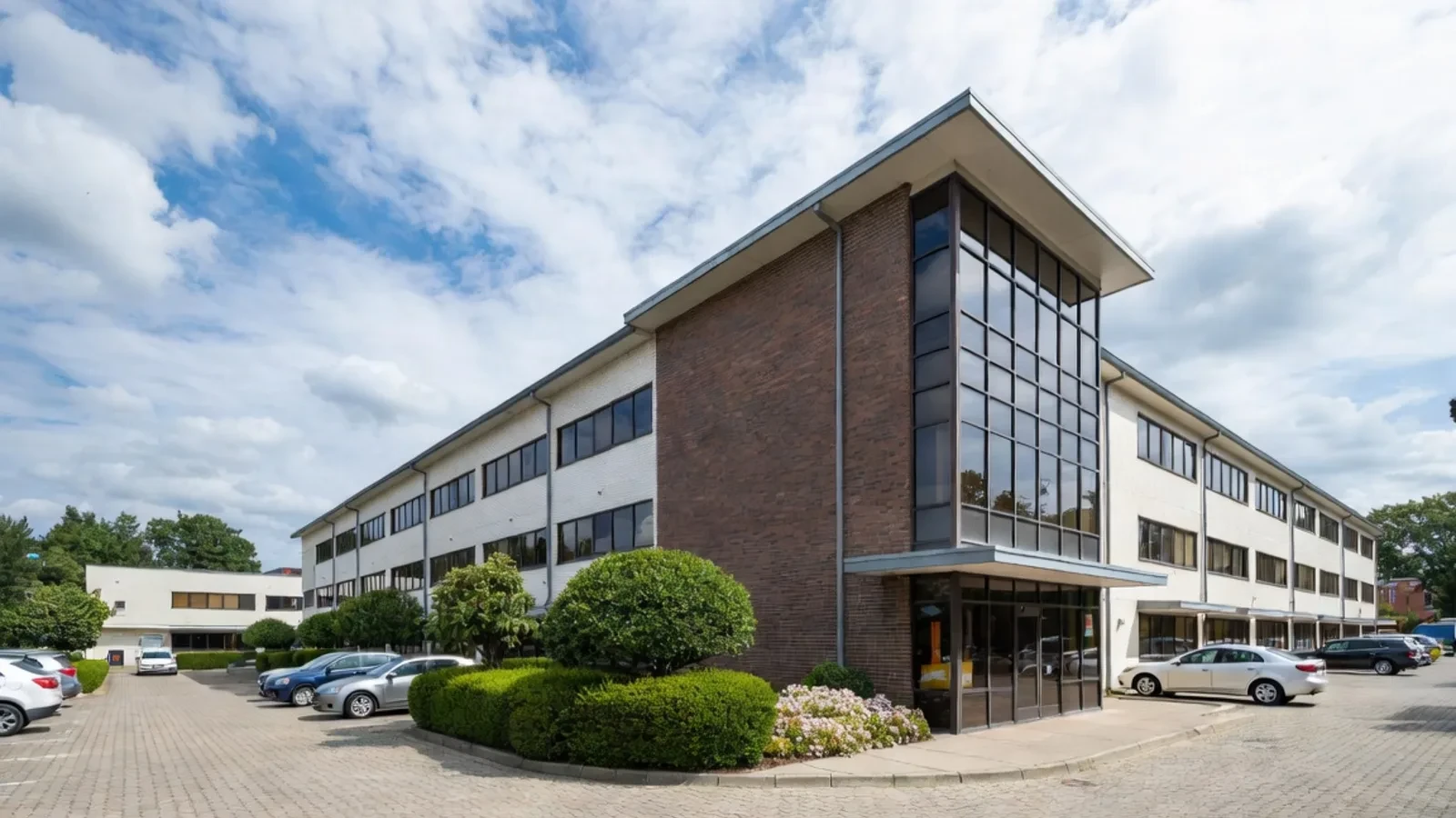 Modern commercial office building with a glass and stone facade